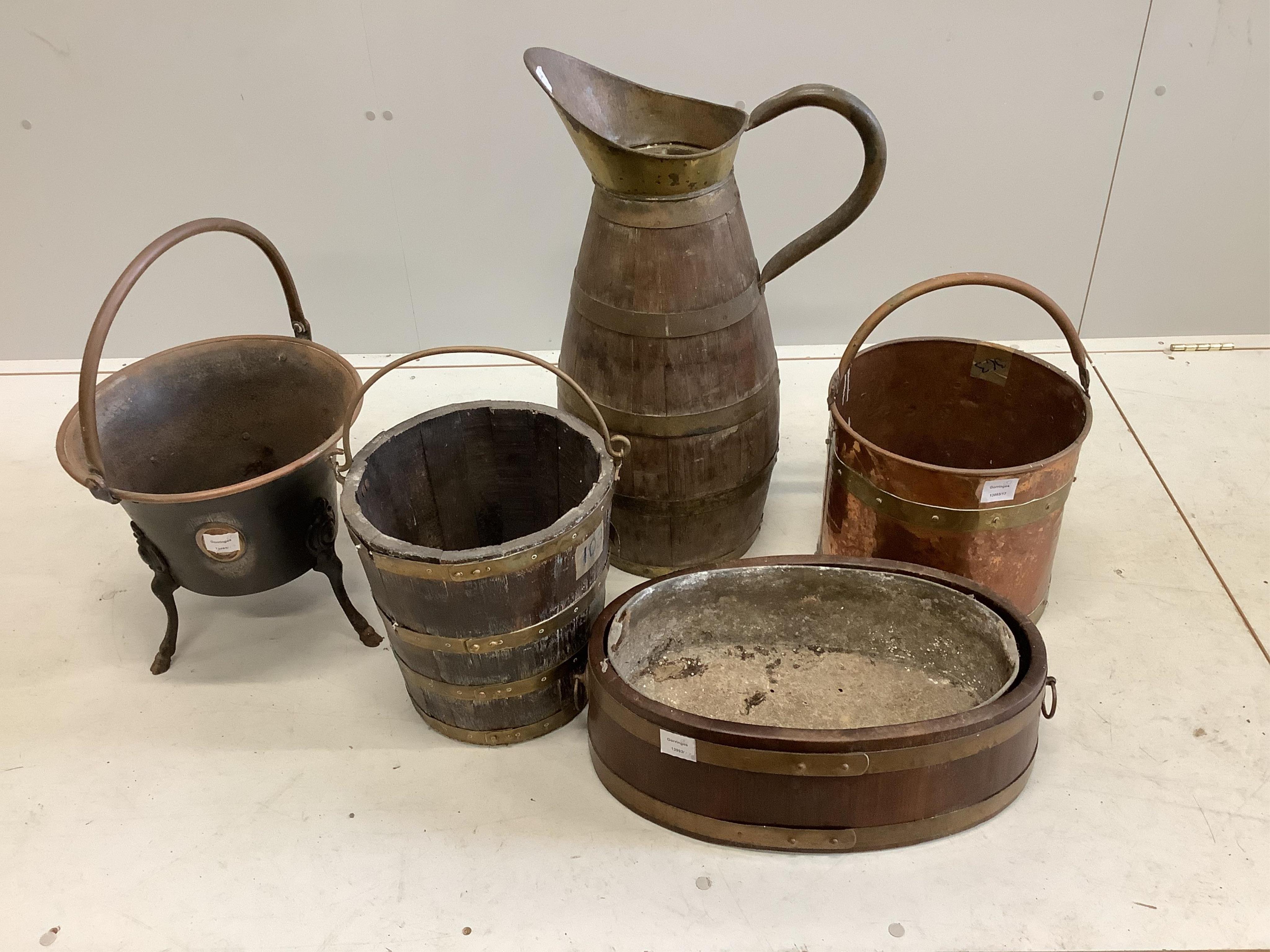 A brass bound staved oak pitcher, height 70cm, a bucket, a planter, two copper coal buckets and a brass fender. Condition - weathered, otherwise fair